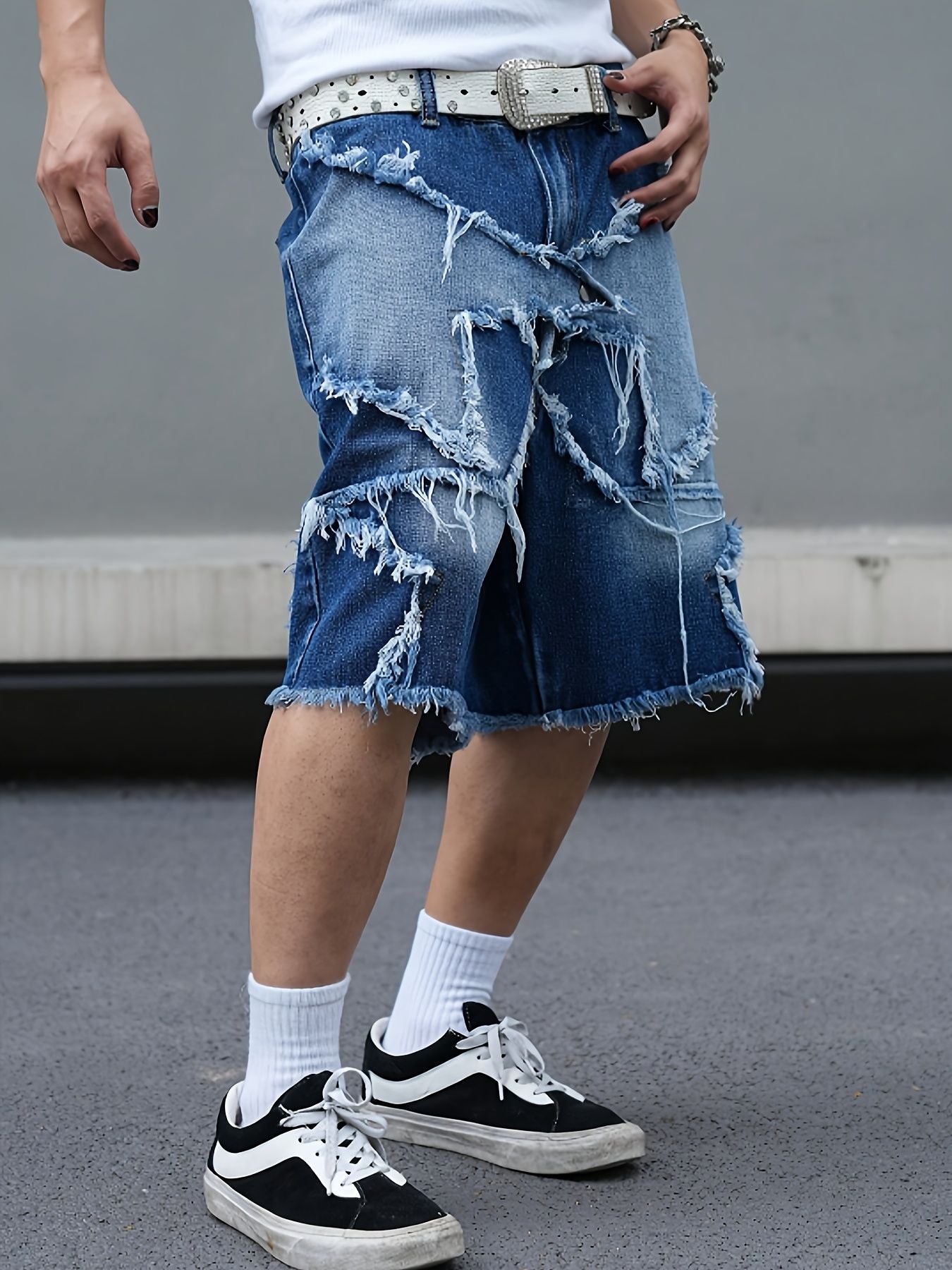 Men's tattered denim shorts with adhesive tape