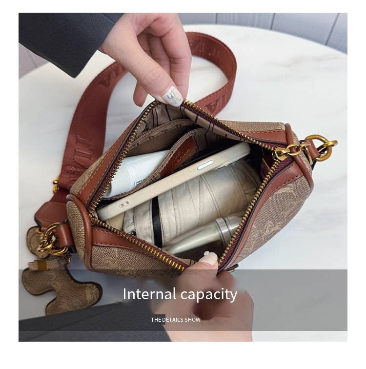 Classic style handbag with strap, featuring a shoulder-sling design, suitable for women, with a bag shape resembling