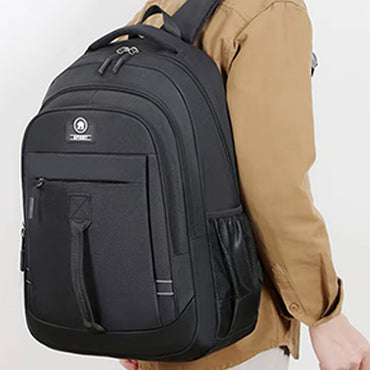 The men's backpack is suitable for business trips. It has a hand-held design with multiple pockets and is a book bag.