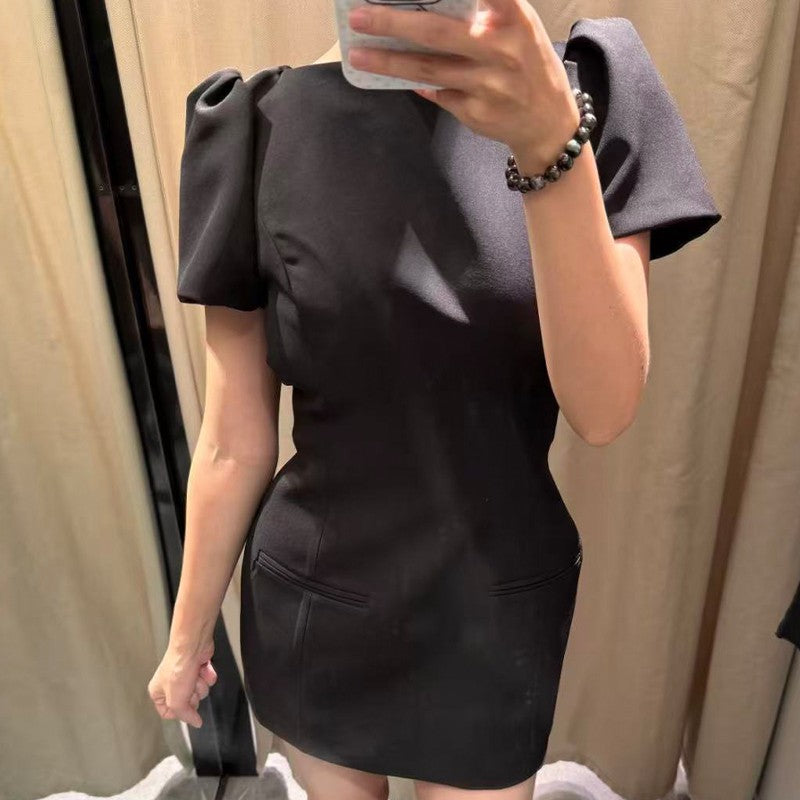 Women's black short puff sleeve mini dress with a stylish boat neckline design and pocket details, suitable for elegant occasion