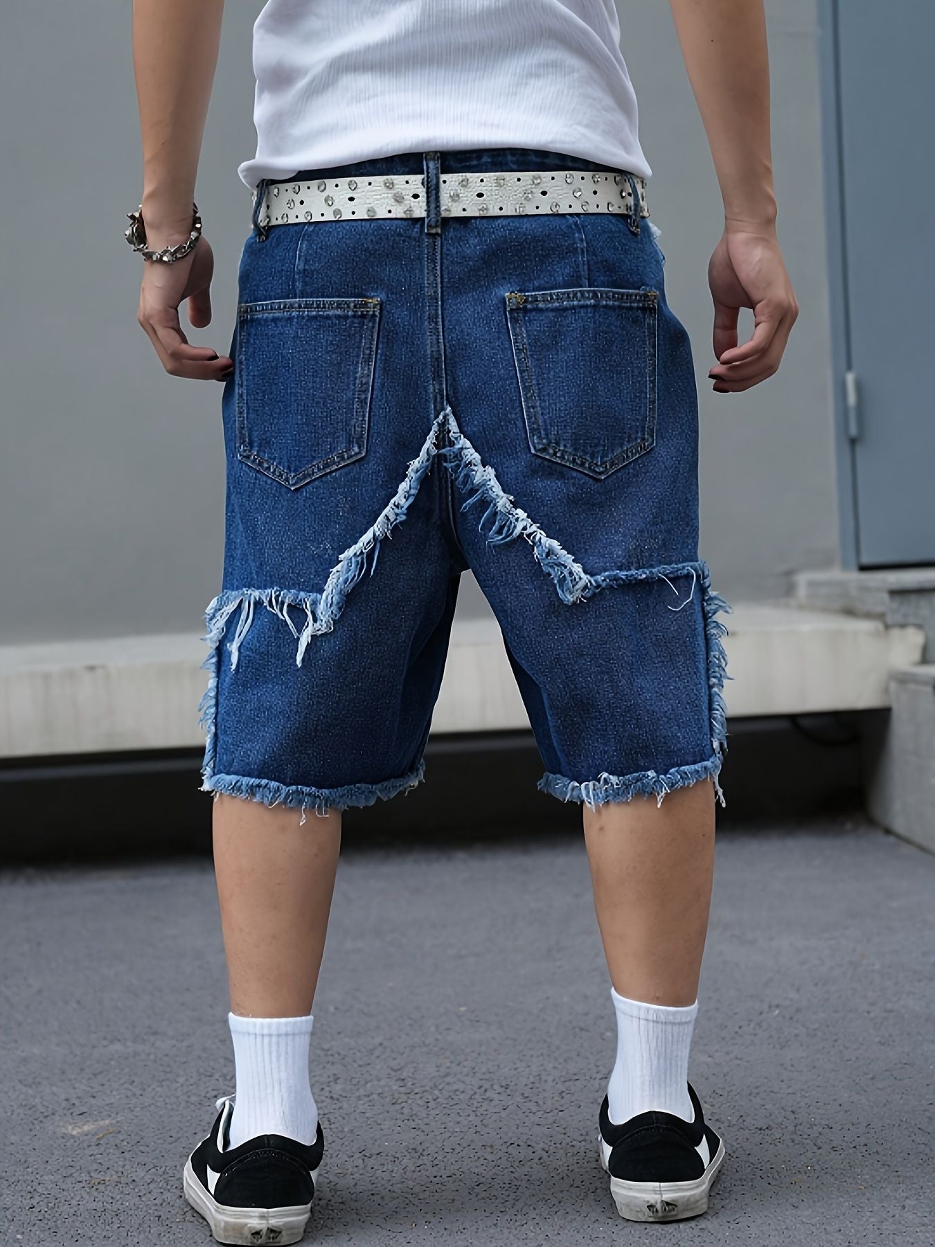 Men's tattered denim shorts with adhesive tape