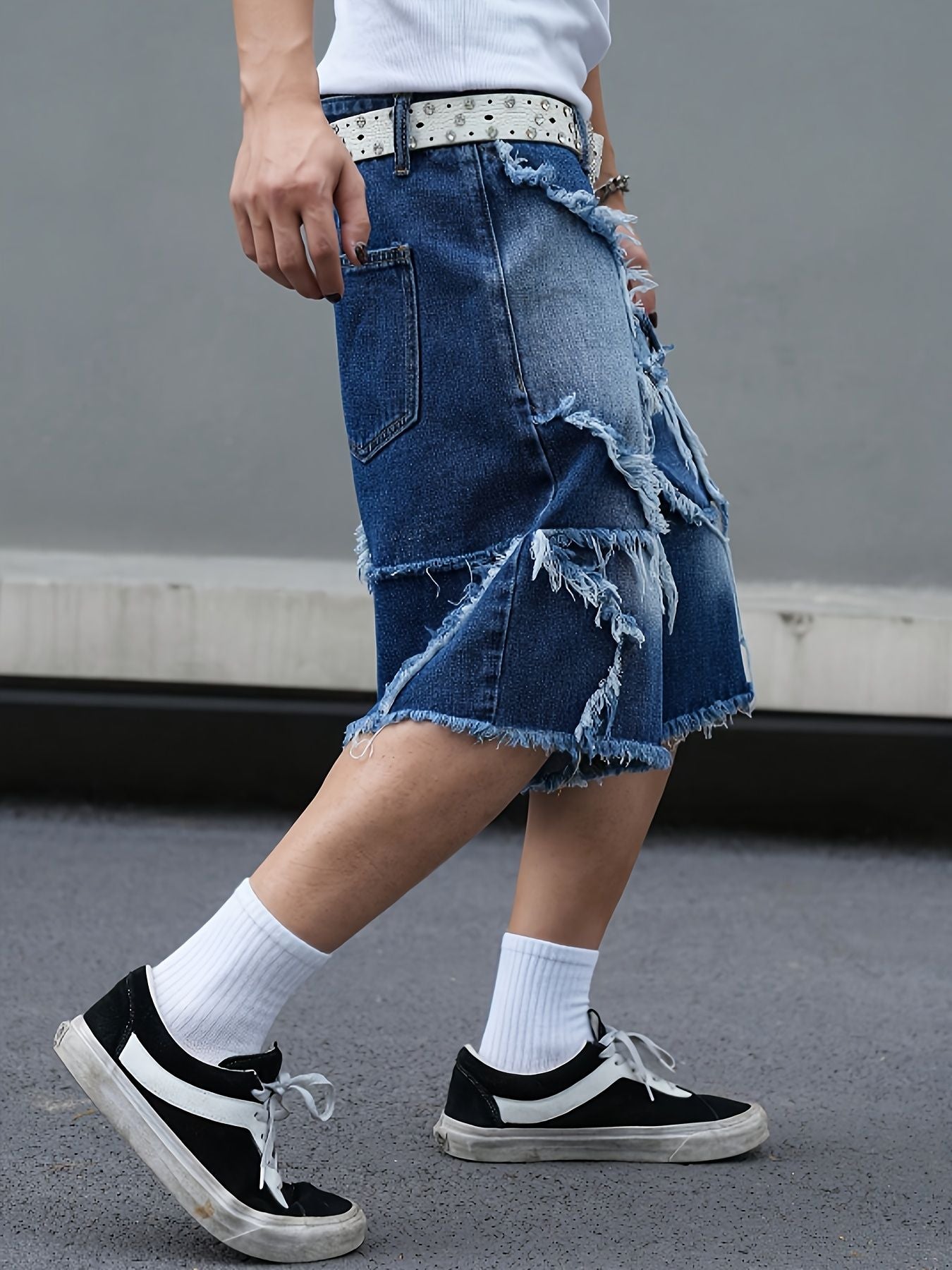 Men's tattered denim shorts with adhesive tape