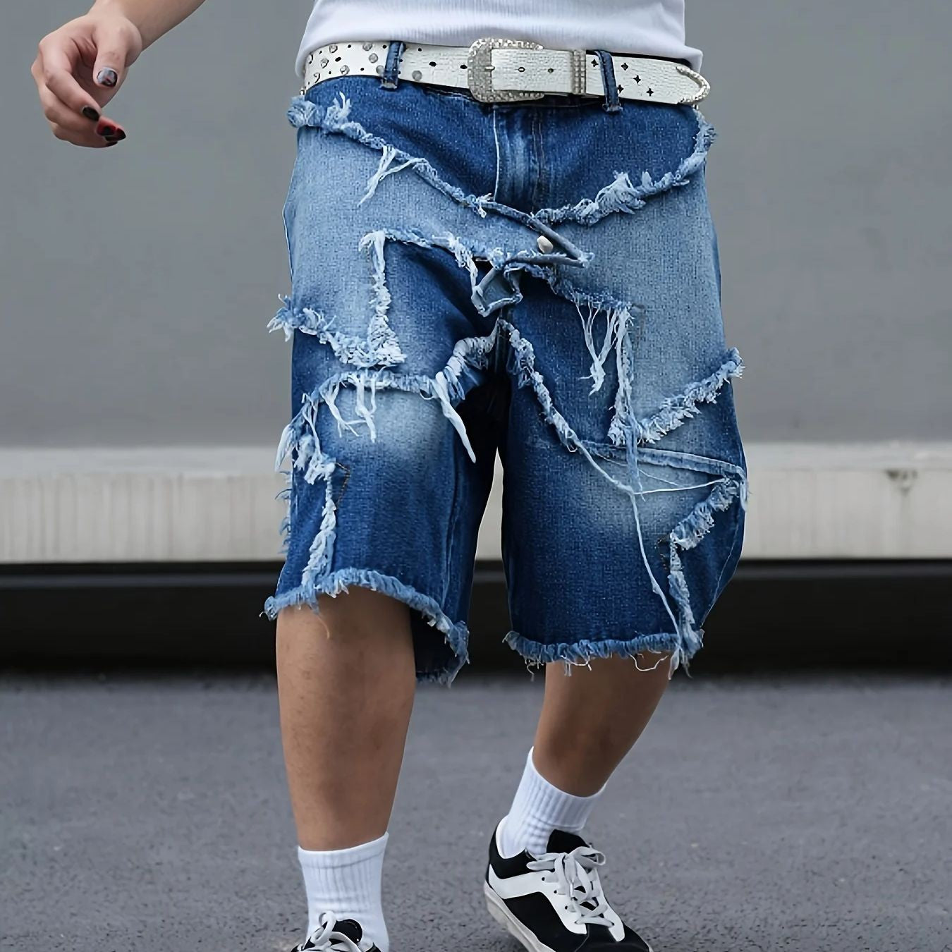 Men's tattered denim shorts with adhesive tape