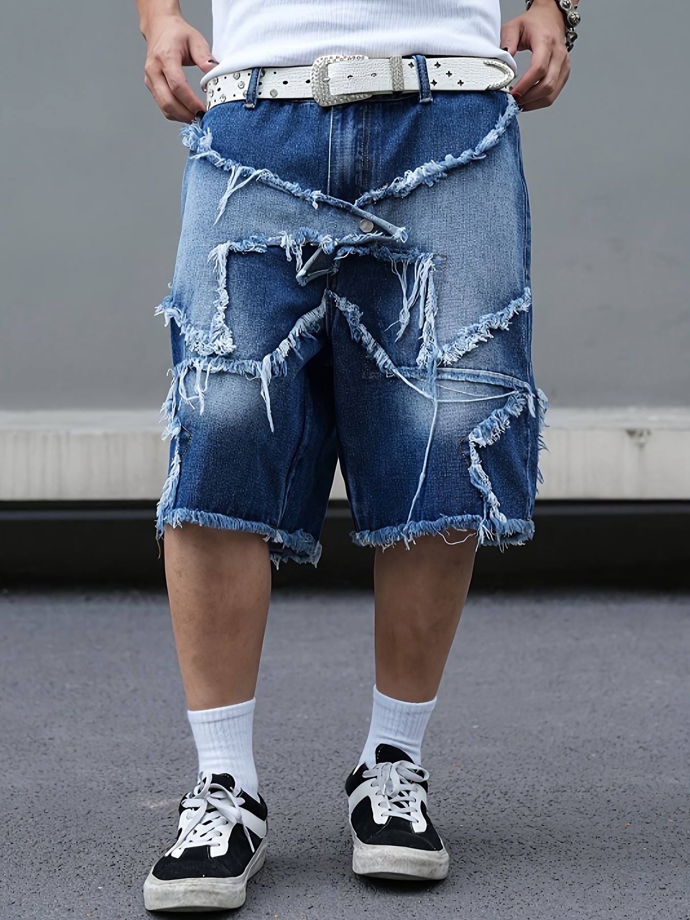 Men's tattered denim shorts with adhesive tape